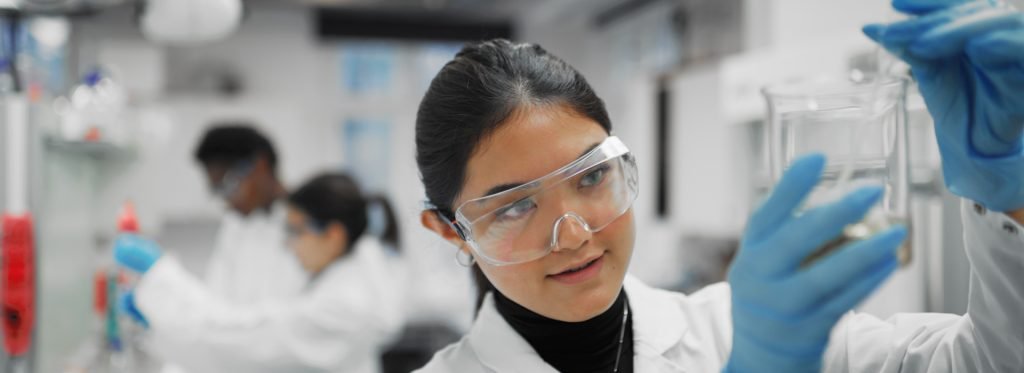 Scientist holding up liquid in a laboratory